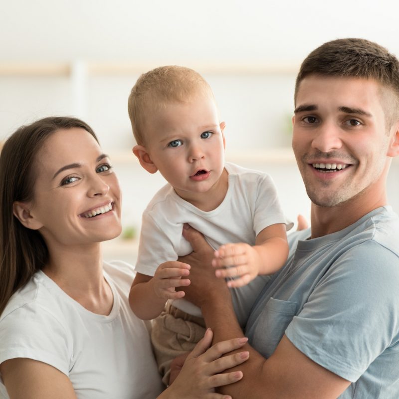 Millennial Family. Portrait Of Happy Young Mother And Father With Infant Child